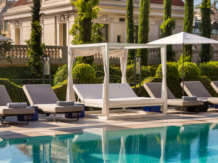 Lounge chairs shaded by umbrellas or cabanas offer a place to relax.