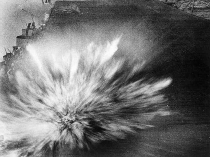 A bomb dropped by a Japanese dive bomber explodes on the Enterprise