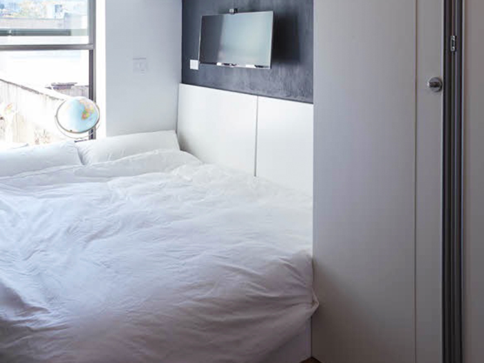 ... and can transform into a guest bed. The desk folds up on the wall to accommodate the bed.