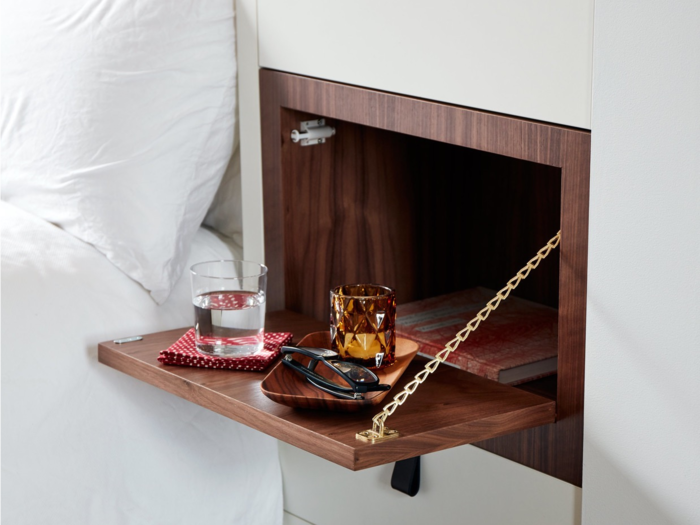 Small touches such as this retractable night table next to the bed make the space even more adaptable.