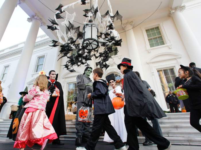 Adults dressed as Dracula and Frankenstein doled out treats to costumed children in 2010.