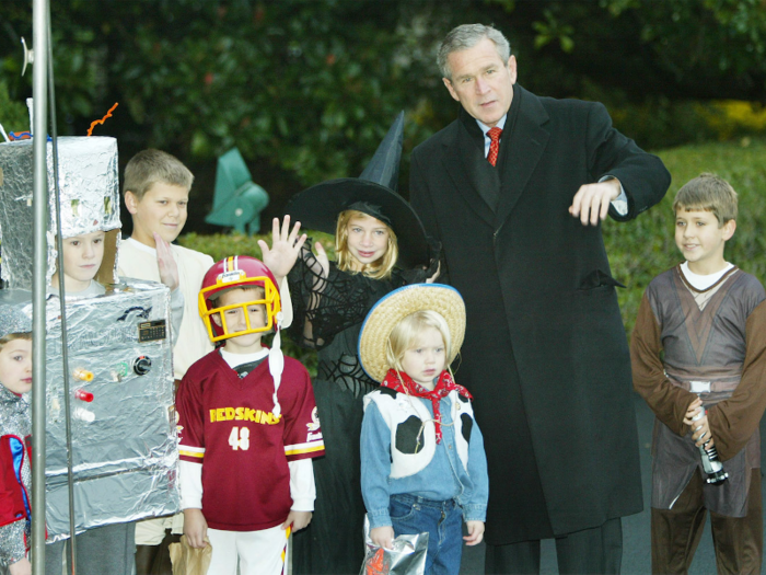 President George W. Bush posed with local children who were trick-or-treating at the White House on Halloween in 2002.