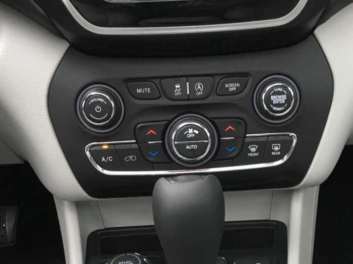 ... Through center stack-mounted buttons.