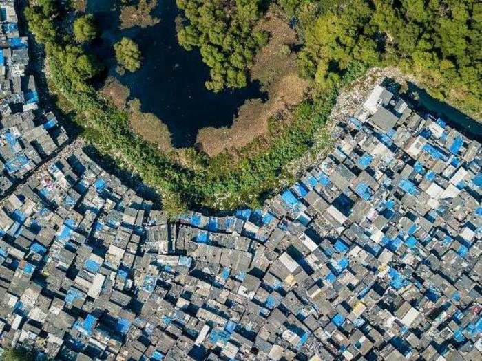 The slum runs up against the Maharashtra Nature Park, a green oasis amid a sea of concrete.