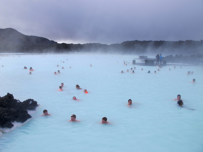 The bathers in this photo, for instance, are in stark contrast to the bystanders fully bundled up in winter gear on the right side.