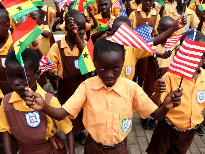 School children were on hand to welcome the American first lady, waving tiny Ghanaian and American flags.