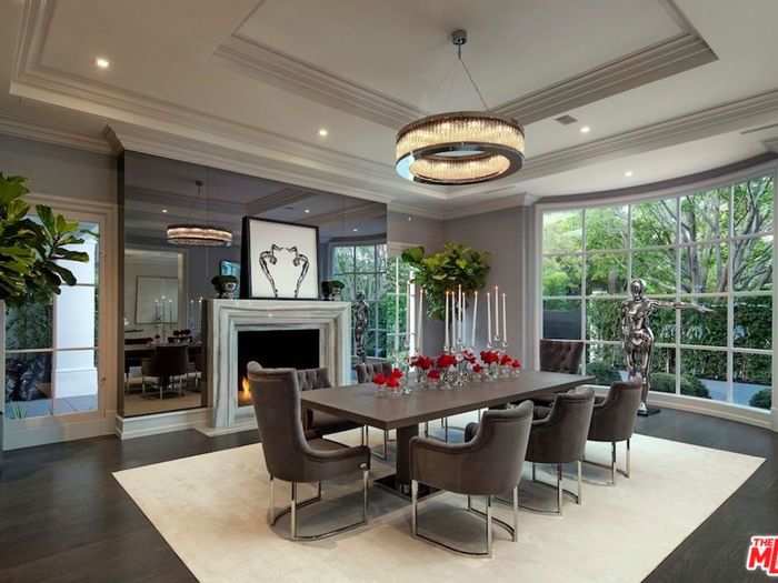 Breakfast, lunch, and dinner are probably served up here, in this dining room with large windows and a floor-to-ceiling mirror that surrounds a big fireplace.