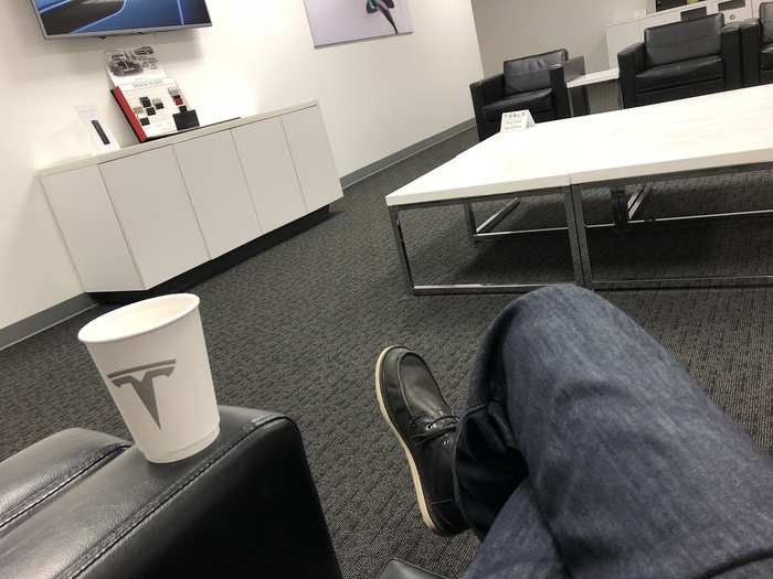 It was at a Tesla store, where I could relax in the waiting room with a beverage ...