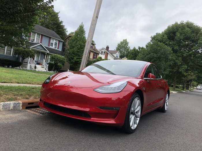 The Model 3 is sleek, not overly curvaceous, and something of a hybrid of mid-size and full-size sedan. No grille because ... there