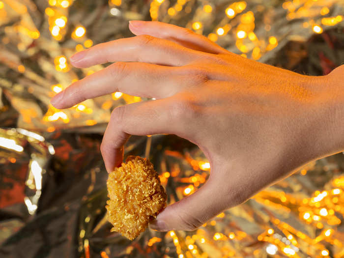 The chicken is made by battering Popeyes classic spicy chicken with champagne, then tossing the wings in edible 24-karat gold flakes.