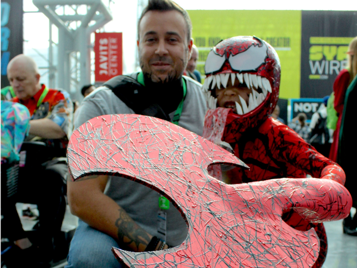 Jose Tirado cosplayed as Eddie Brock before he fully turned into Venom, and his son dressed as Carnage, both from Marvel Comics. Tirado said his own face paint was a last-minute addition to make his son feel more comfortable.