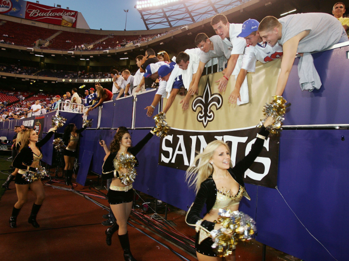 In addition to making appearances, cheerleaders are sometimes expected to interact with fans at games...