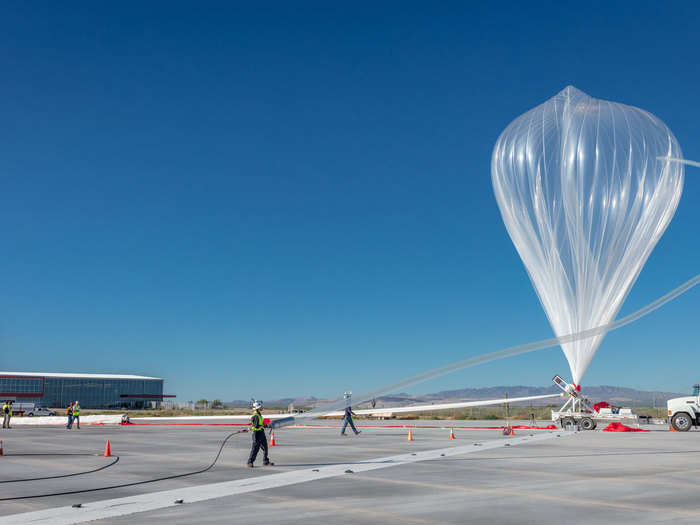 The lower 75% of the balloon is held back and released in a coordinated effort to ensure the payload doesn