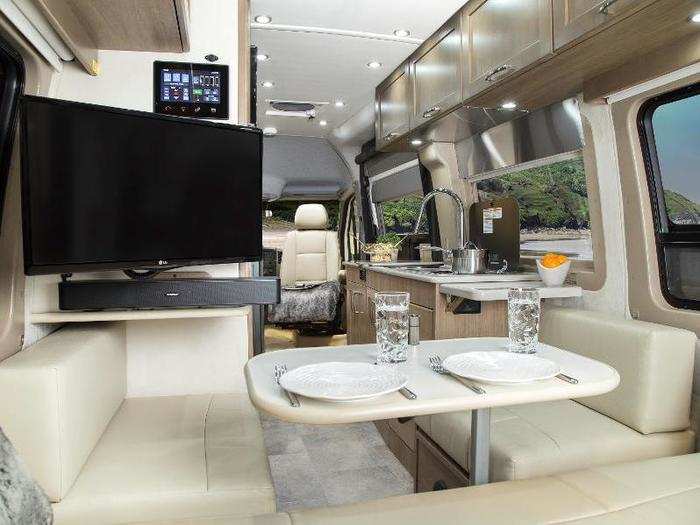 The Pleasure Way Plateau FL is also built on a Mercedes-Benz Sprinter chassis. The Class B RV features a memory foam power sofa, 24" flat-screen TV, rear bed arrangement, and two swivel chairs that can fold to form a second dining and work area.