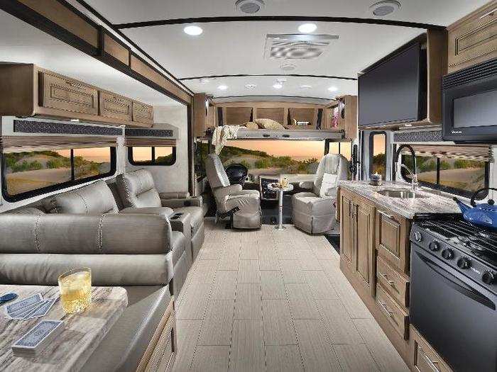 The Forest River FR3 interior features a one-piece fiberglass roof, Oakley seal decor, ultra leather seating with double stitching, a 40" LED TV, 3-burner cooktop, and stainless steel lavatory.