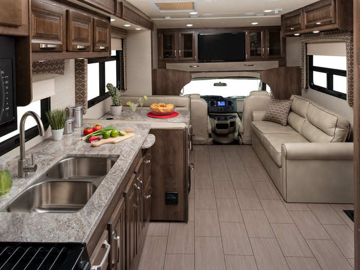 The Jayco Greyhawk interior features frameless windows, theater seats, heated side mirrors, 24" LED TV, and a 55-gallon fuel tank.