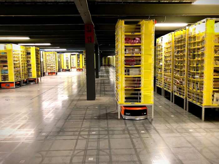 In one part of the facility, robots like the ones hanging in the entryway are responsible for moving inventory to and fro.