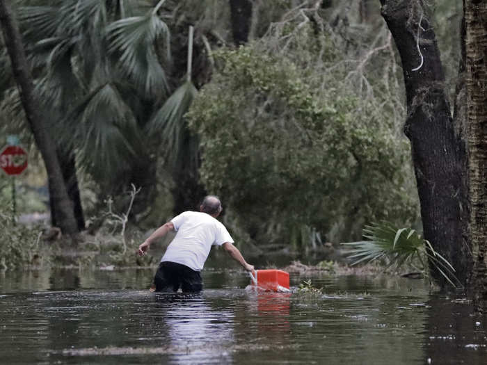 Severe flooding has hit the area. Here, a resident of St. Marks, Florida marches out of the floodwaters near his home.