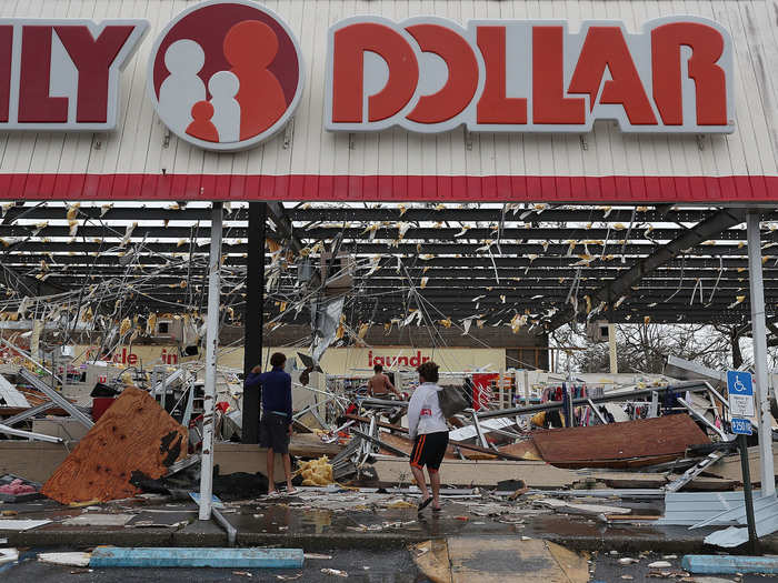 People look at a damaged Family Dollar store.