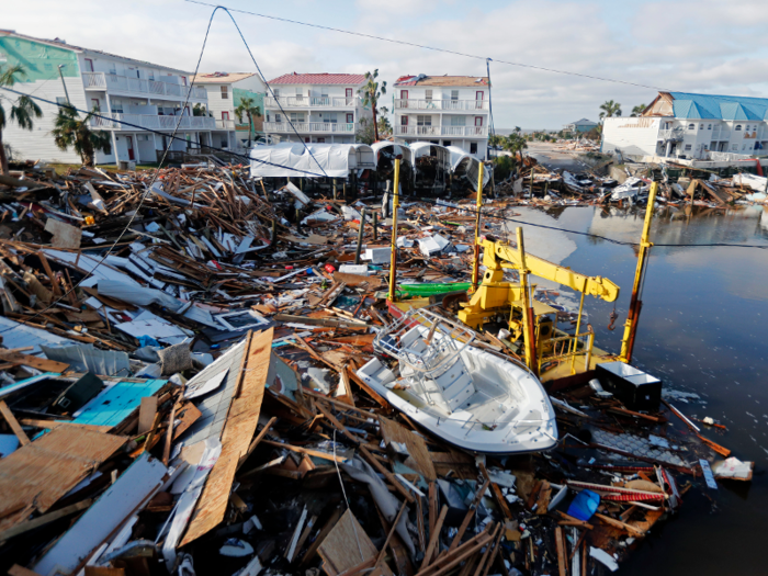 Here, a small boat sits amid debris in Mexico Beach.