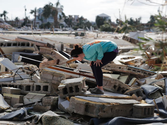 Mishelle McPherson searched for a friend in the rubble of her home in Mexico Beach, since the friend did not leave before Michael hit.