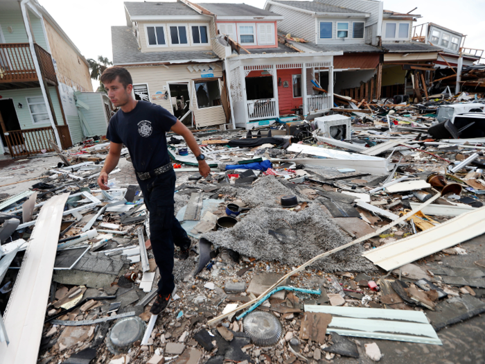 Here, firefighter Austin Schlarb performs a door-to-door search in Mexico Beach.