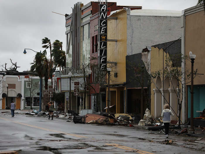 After: Residents walk past damaged stores