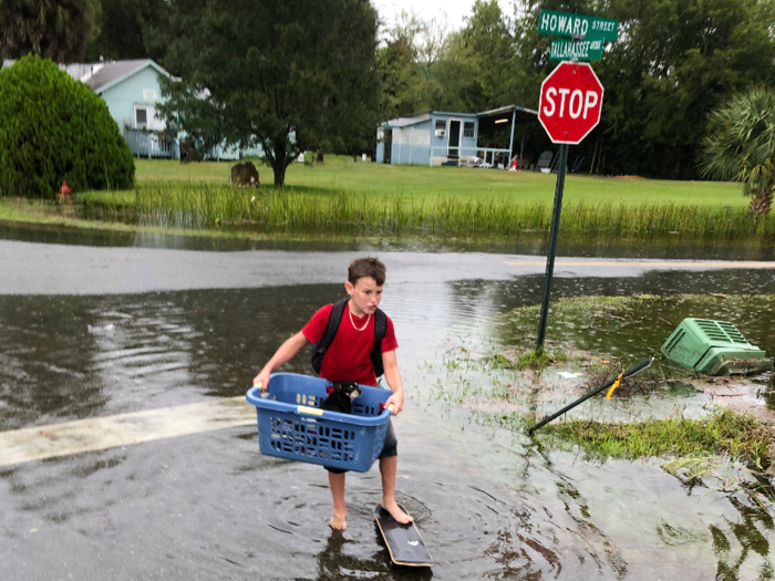 After: 11-year-old resident Jayden Morgan evacuates his home due to flooding