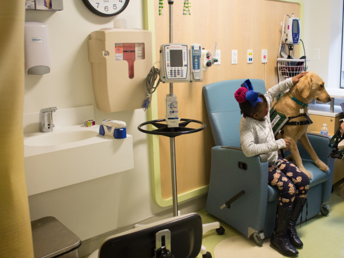 Zakyra is getting her flu shot today, and Professor is sitting with her to help distract her from the pain.