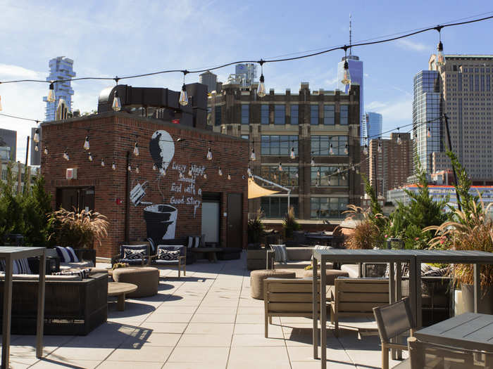 We stepped outside to the outdoor area, which felt very laid-back with its wooden furniture, assorted plants, and vintage-style string lights. It offers a decent view of New York City