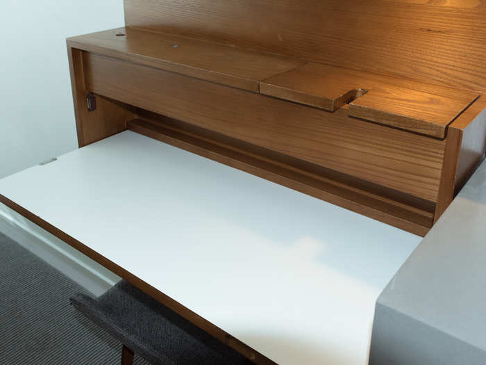 When opened, the desk looks like this, but the white section can also fold up vertically against the wall when it