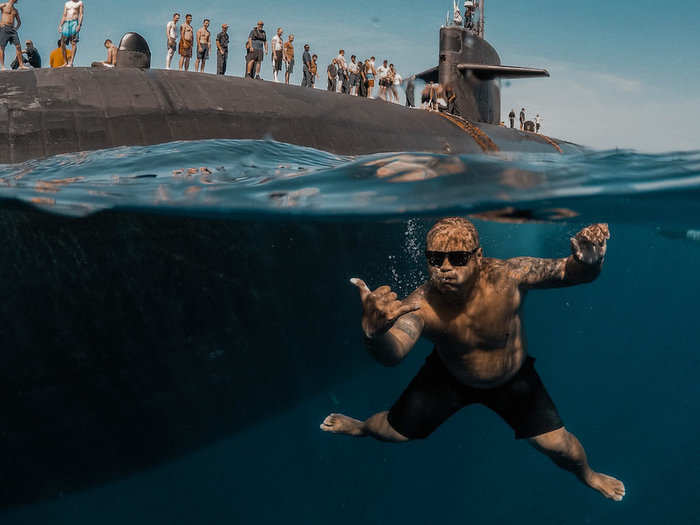 Sailors assigned to Los Angeles-class fast-attack submarine USS Olympia (SSN 717) participate in a swim call at sea on July 3, 2018.