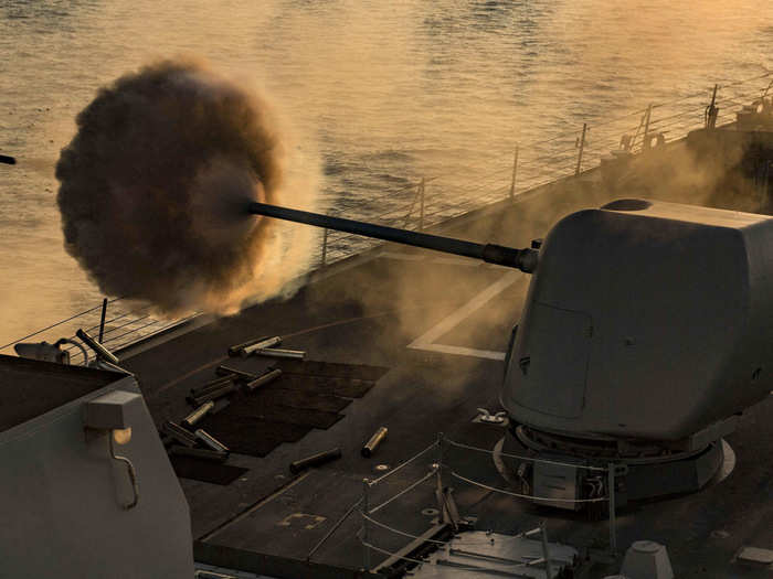 The Arleigh Burke-class guided-missile destroyer USS Carney (DDG 64) fires its 5 inch gun during a live fire exercise on Sept. 24, 2018.