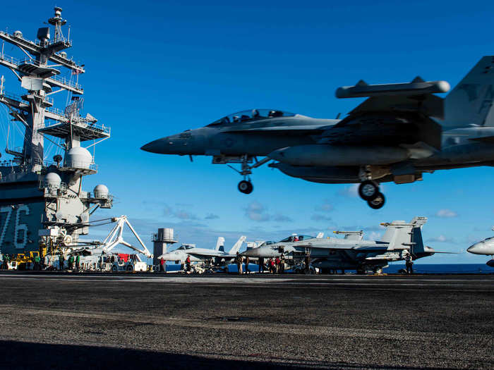 An EA-18G Growler assigned to Electronic Attack Squadron (VFA) 141 lands on the flight deck of the Navy