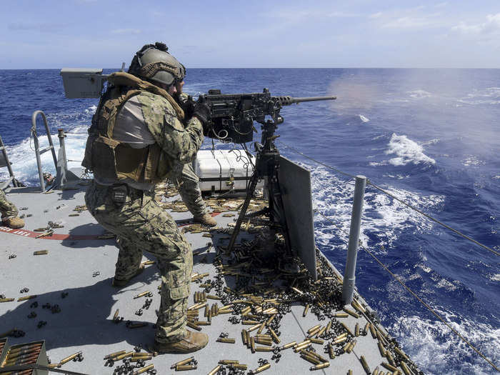 Gunner’s Mate 2nd Class Michael DeCesare, assigned to Coastal Riverine Squadron (CRS) 4, fires an M2 machine gun aboard a Mark VI patrol boat during a crew served weapons qualification in the Philippine Sea on April 12, 2018