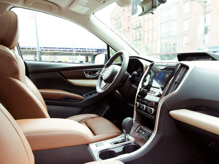 The interior feels solidly put together with good-quality materials. The leather upholstery is soft to the touch, and the plastics look and feel robust. The dark tan leather and wood grain accents add an extra dash of luxury to the business-like cabin.