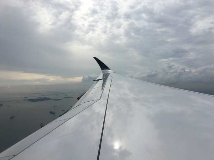 As we approach Singapore, we fly over the armada of cargo ships waiting to enter its ports.