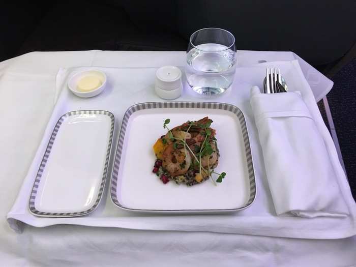 About two hours into the flight, the first meal service commenced. The multi-course meal opened with sauteed prawns on a quinoa salad with semi-dried tomato and snow pea tendrils. The appetizer was flavorful, crisp, and refreshing.