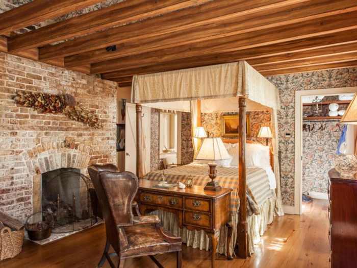 And its bedroom sports a fireplace and a beige bed canopy.