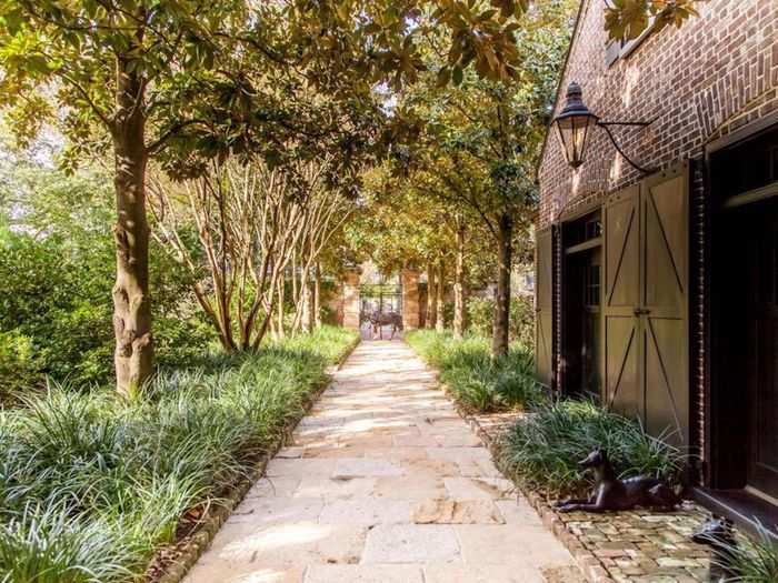 Past the gates, and the brick walls that line the entire property, is a carriage house.