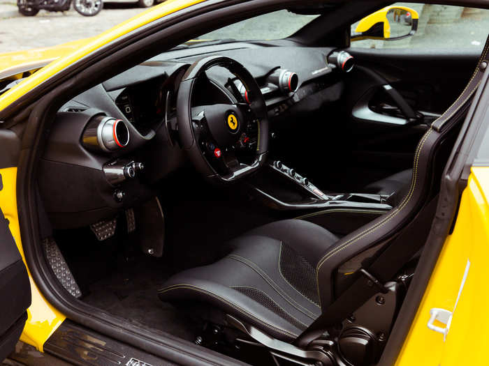 Our tester was a symphony of black leather, yellow topstitched accents, carbon fiber, brushed metal, and a dash of Ferrari red here and there.