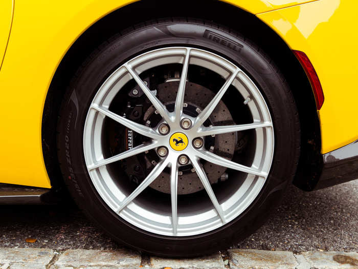 Spidery forged racing wheels, outfitted with Pirelli P-Zeros, barely conceal ...