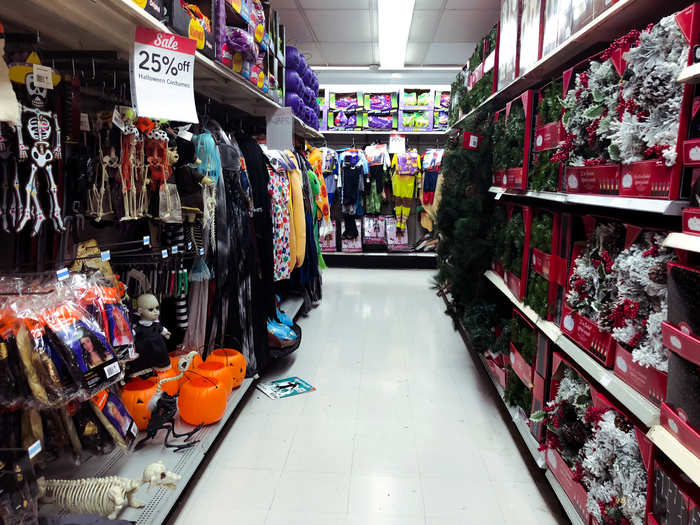 The holiday department was alternating shelves between Halloween and Christmas.