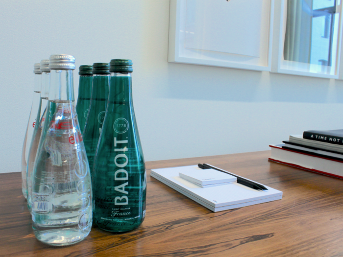 Complimentary bottles of sparkling water were set out on tables for members. I resisted the urge to snatch one.