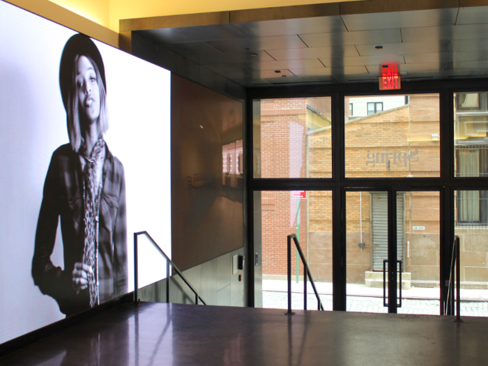 The entryway was sleek and shiny, all black and gray tones. I was greeted by my tour guides, who showed me how to check in on an iPad, and then whisked me away to the elevator.