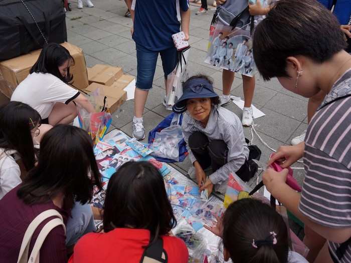 Business was brisk for vendors selling unofficial merchandise. BTS fans were hurriedly grabbing whatever memorabilia they could. The cash was flowing.