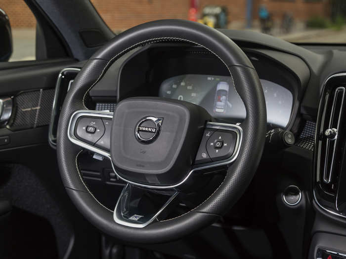 The R-Design steering wheel has the usual buttons and knobs to operate vehicle functions, as well as some nifty topstitching. It