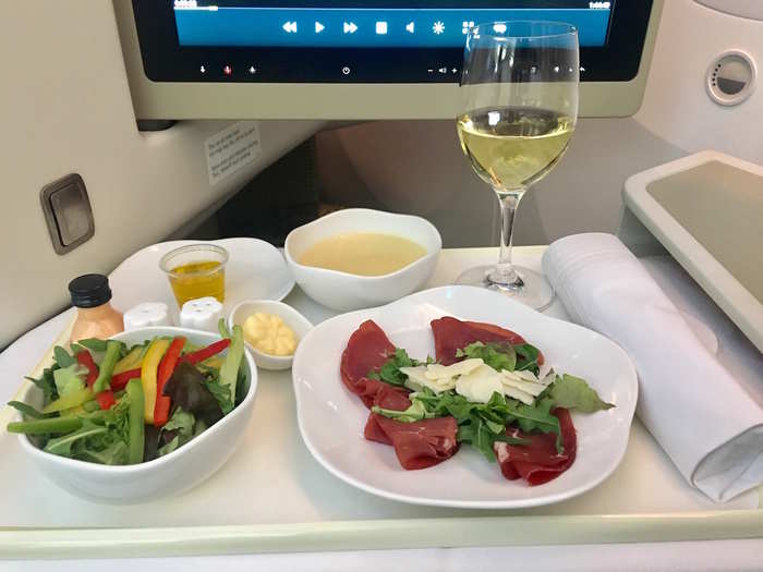 All business class meals are provided on proper chinaware, with metal utensils and a sturdy cloth napkin. I ordered the bresaola beef with vegetable salad as a starter.