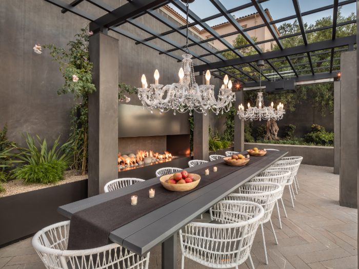 The patio area offers yet another dining area, replete with two chandeliers and more views across the bay.