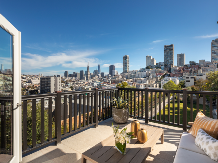 The master bedroom opens up to a deck with sweeping views of the city.